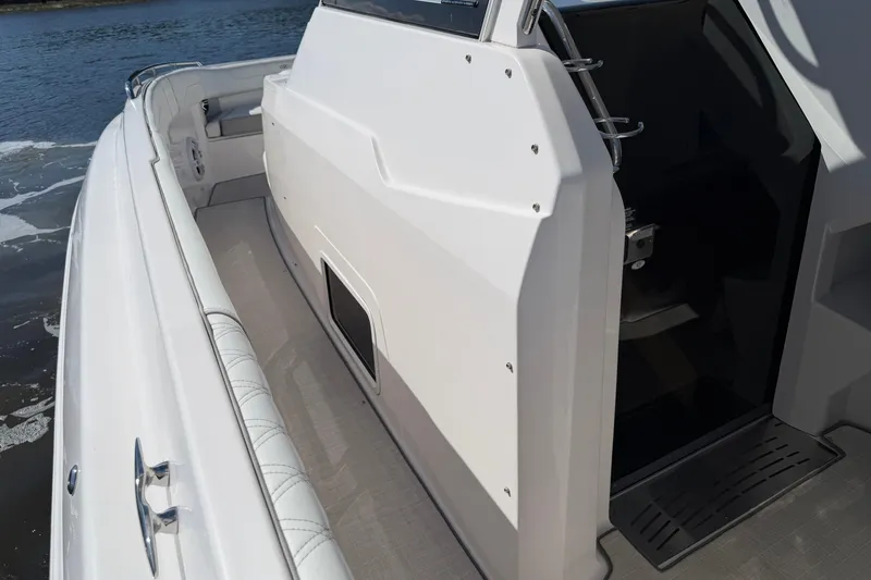 Slide: The Image of 2021 Regal 33 SAV boat interior with open cabin door, docked on water. - 29