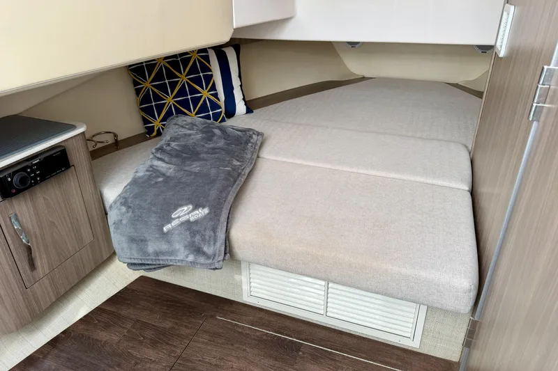 Slide: The Image of 2021 Regal 33 SAV cabin interior with cozy bedding and modern design. - 34