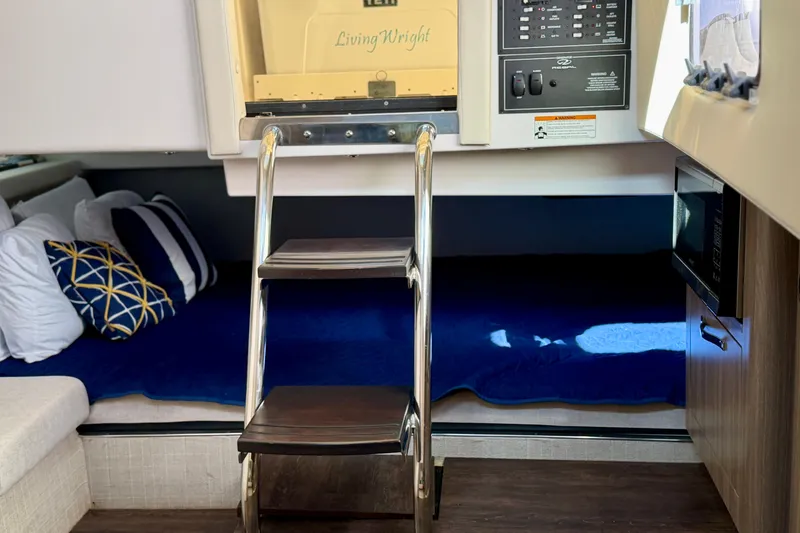 Slide: The Image of 2021 Regal 33 SAV interior with ladder, cozy bedding, and control panel. - 36