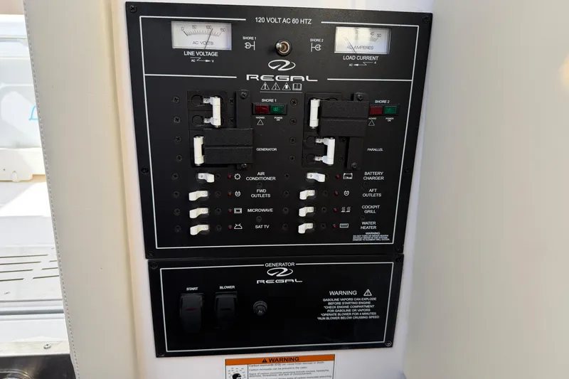 Slide: The Image of Electrical control panel of a 2021 Regal 33 SAV boat, featuring switches and gauges. - 39