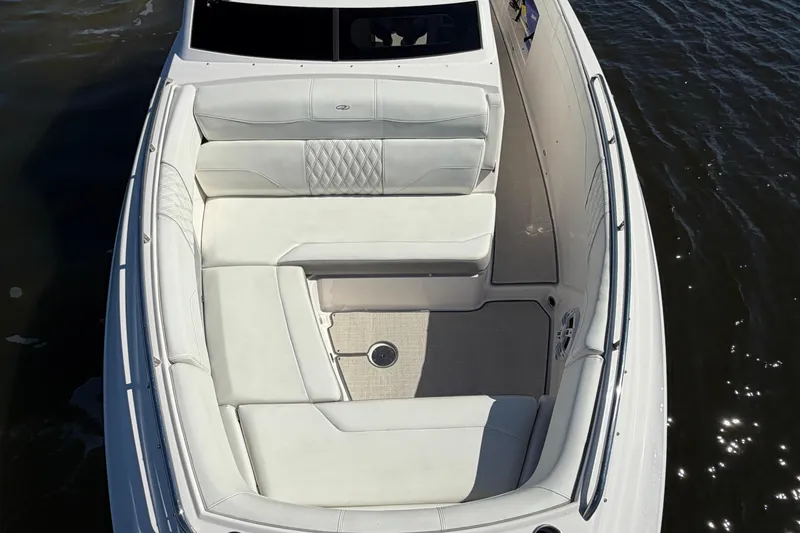 Slide: The Image of 2021 Regal 33 SAV boat with luxurious white seating on calm water. - 8