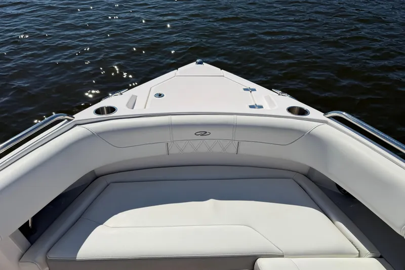 Slide: The Image of Bow seating area of 2021 Regal 33 SAV boat on water. - 9