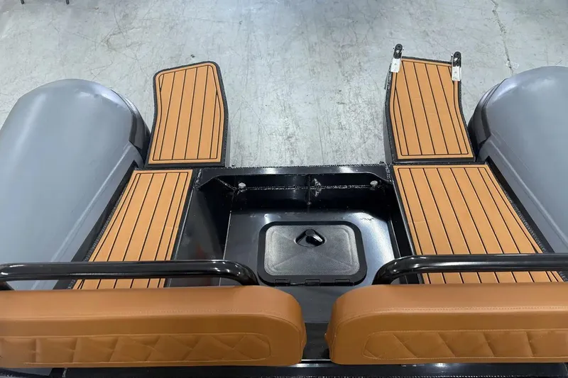 Slide: The Image of Manufacturer Provided Image: 2025 East Marine 700 boat interior with brown cushioned seats and wooden flooring. - 10