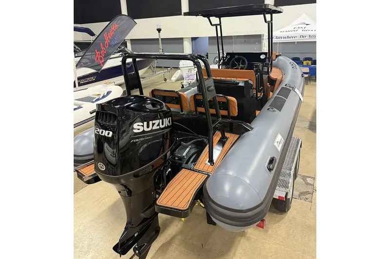 Slide: The Image of Manufacturer Provided Image: 2025 East Marine 700 boat with Suzuki 200 engine displayed indoors. - 3