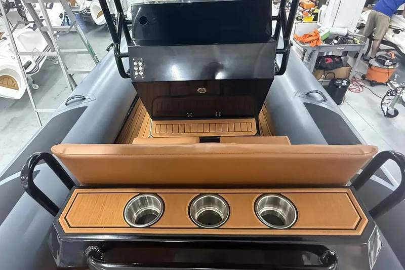 Slide: The Image of Manufacturer Provided Image: 2025 East Marine 700 boat interior with cup holders and sleek design. - 8