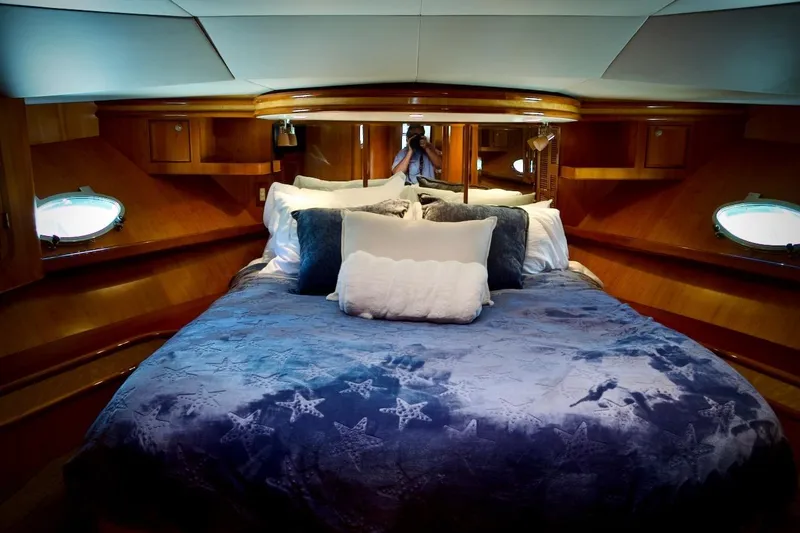 Slide: The Image of Luxurious cabin interior of 2002 Mikelson 50 Sportfisher yacht with plush bedding. - 13
