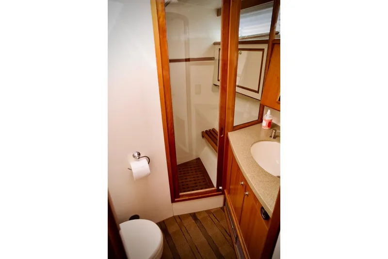 Slide: The Image of Bathroom interior of 2002 Mikelson 50 Sportfisher yacht with wooden accents and modern fixtures. - 15