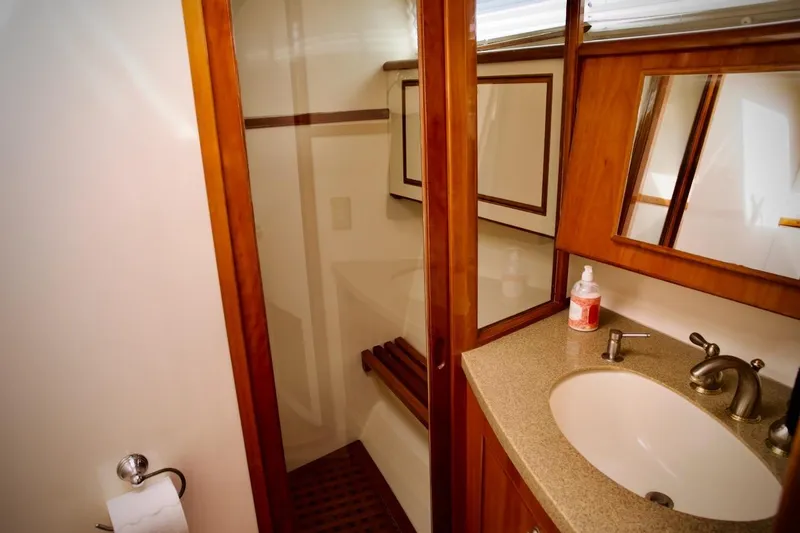 Slide: The Image of Luxurious bathroom in 2002 Mikelson 50 Sportfisher yacht with wood accents and modern fixtures. - 16
