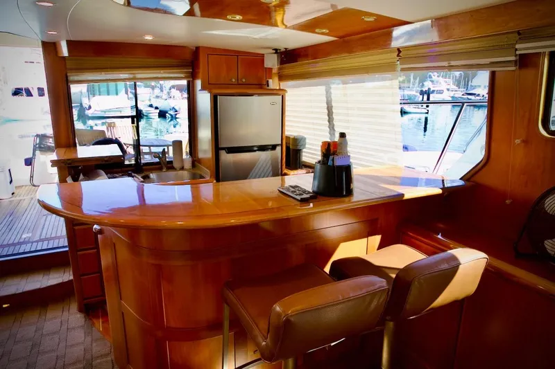Slide: The Image of Luxurious interior of 2002 Mikelson 50 Sportfisher yacht with bar and seating area. - 21