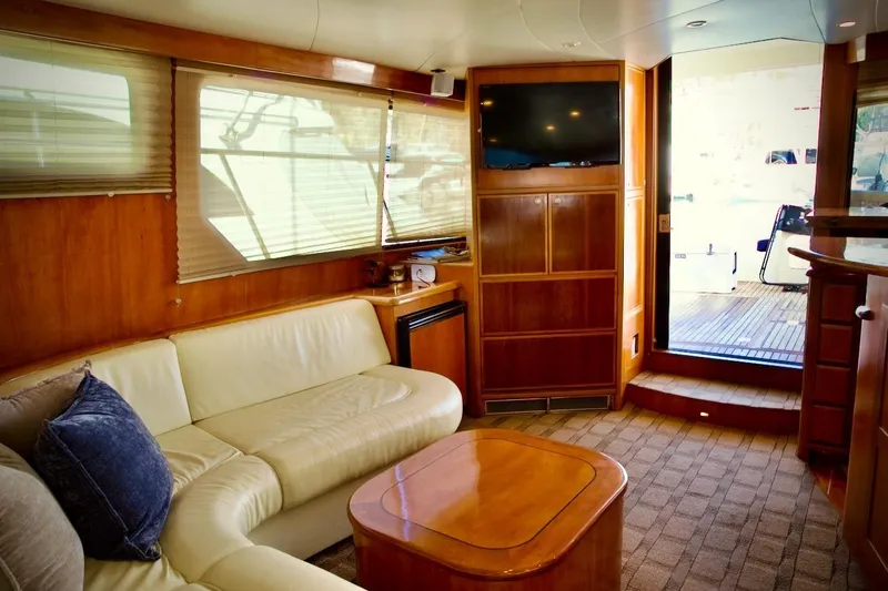 Slide: The Image of Luxurious interior of 2002 Mikelson 50 Sportfisher yacht with leather seating and wooden finishes. - 24