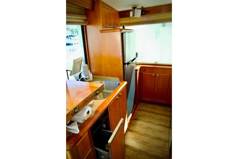 Slide: The Image of Interior of 2002 Mikelson 50 Sportfisher yacht with wooden cabinetry and modern appliances. - 25