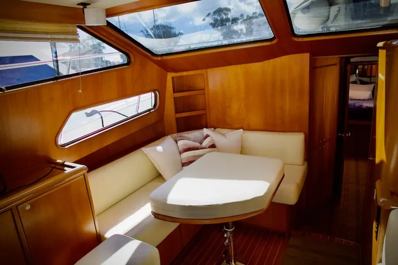 Slide: The Image of Luxurious interior of 2002 Mikelson 50 Sportfisher yacht with cozy seating and wooden finishes. - 26