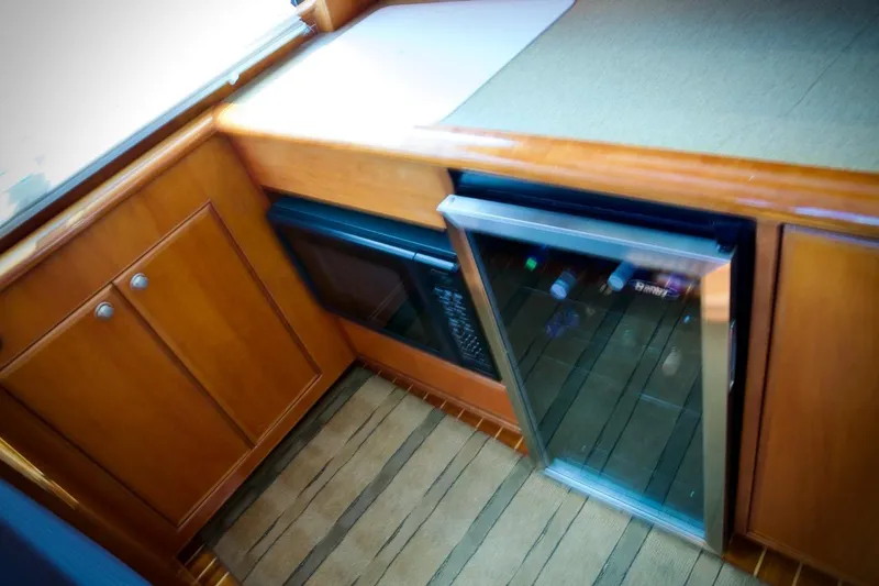 Slide: The Image of 2002 Mikelson 50 Sportfisher interior with wooden cabinetry and built-in appliances. - 27