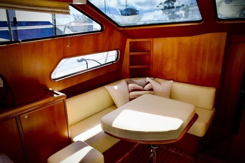 Slide: The Image of Interior of 2002 Mikelson 50 Sportfisher with cozy seating and wooden accents. - 30