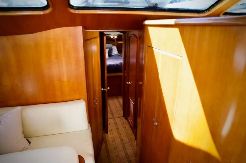 Slide: The Image of Interior of 2002 Mikelson 50 Sportfisher yacht with wooden paneling and cozy seating. - 32