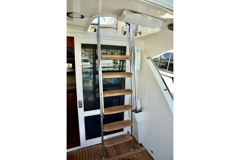 Slide: The Image of Stainless steel and wood ladder on 2002 Mikelson 50 Sportfisher yacht. - 36