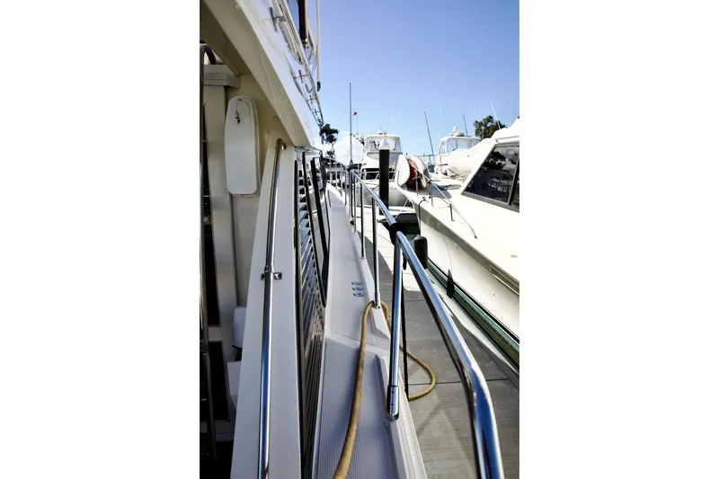 Slide: The Image of 2002 Mikelson 50 Sportfisher yacht docked at marina, side view with railing. - 37
