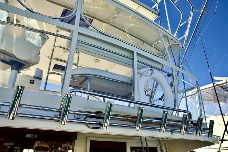 Slide: The Image of 2002 Mikelson 50 Sportfisher yacht, featuring upper deck and fishing rod holders. - 38