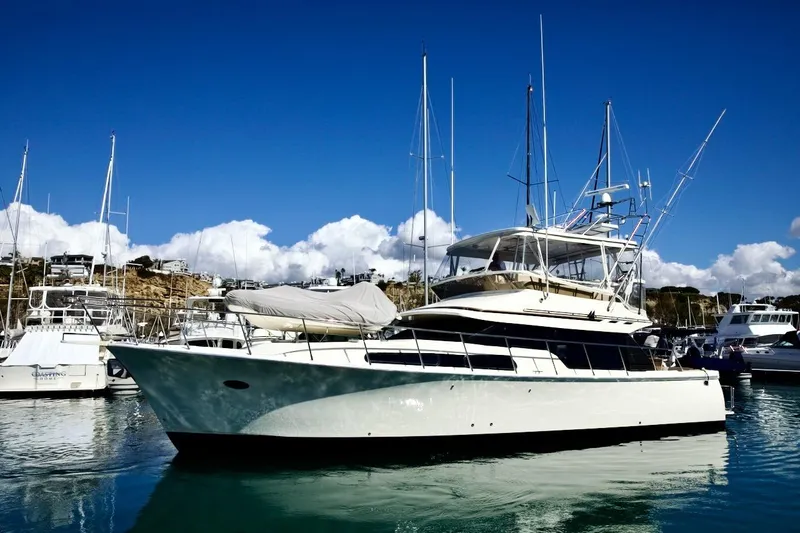 Slide: The Image of 2002 Mikelson 50 Sportfisher yacht docked in a sunny marina. - 4