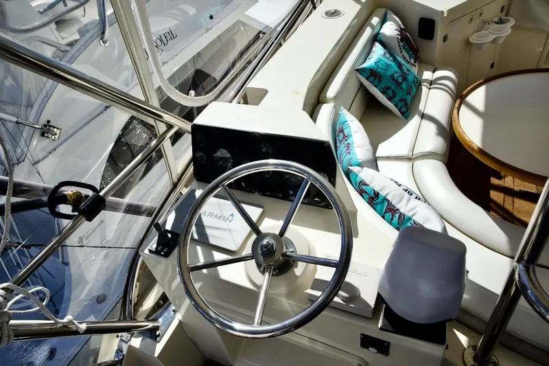 Slide: The Image of Helm of 2002 Mikelson 50 Sportfisher with steering wheel and cushioned seating area. - 41
