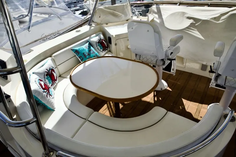 Slide: The Image of Luxurious 2002 Mikelson 50 Sportfisher yacht interior with cushioned seating and table. - 42