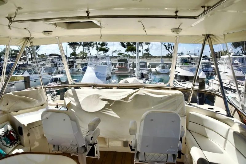Slide: The Image of Interior view of a 2002 Mikelson 50 Sportfisher yacht docked at a marina. - 44