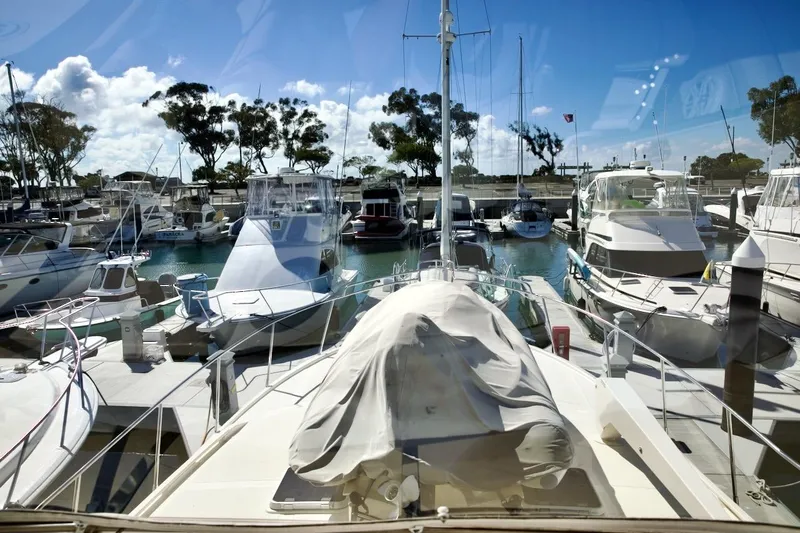 Slide: The Image of Marina view with 2002 Mikelson 50 Sportfisher surrounded by various boats under a clear blue sky. - 47