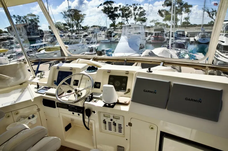 Slide: The Image of Helm of 2002 Mikelson 50 Sportfisher with Garmin navigation, docked at marina. - 48