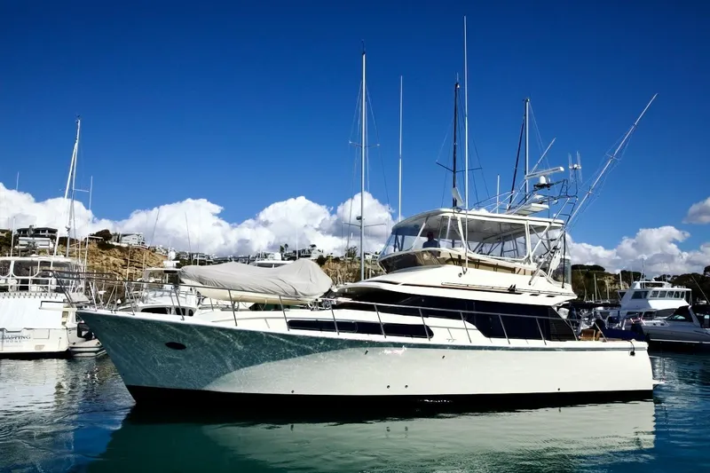 Slide: The Image of 2002 Mikelson 50 Sportfisher yacht docked in a sunny marina. - 5