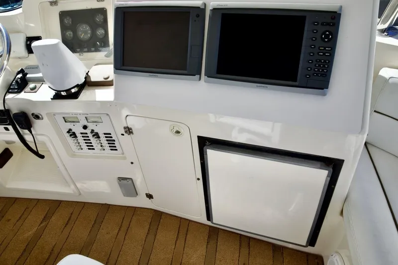 Slide: The Image of Control panel and navigation screens on a 2002 Mikelson 50 Sportfisher yacht. - 53
