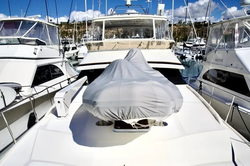 Slide: The Image of 2002 Mikelson 50 Sportfisher yacht docked in marina, covered equipment on deck. - 58