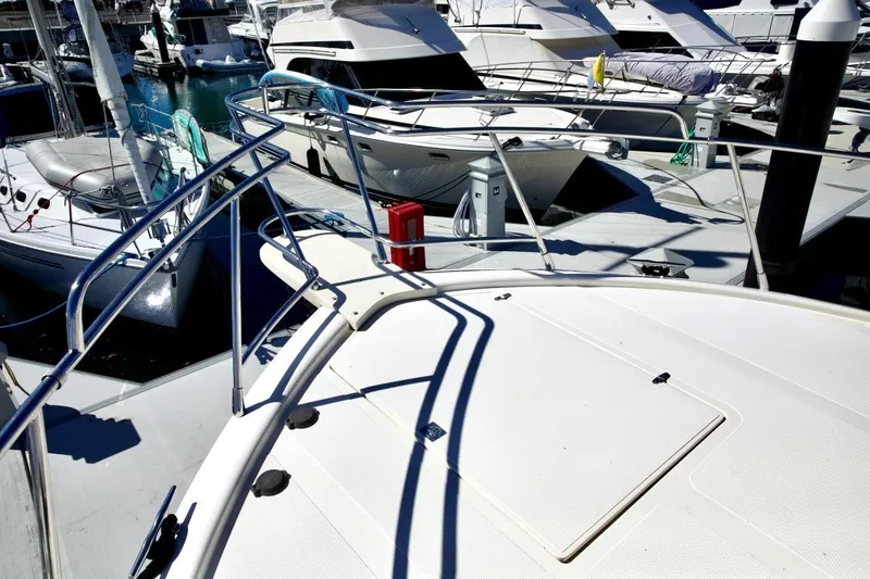 Slide: The Image of 2002 Mikelson 50 Sportfisher yacht docked among other boats in a marina. - 69