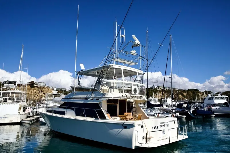 Slide: The Image of 2002 Mikelson 50 Sportfisher yacht docked in a sunny marina. - 7