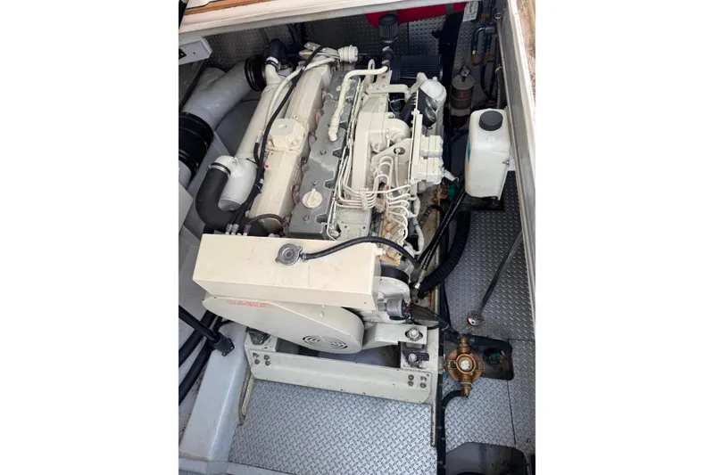 Slide: The Image of Engine compartment of a 2002 Mikelson 50 Sportfisher, showcasing detailed mechanical components. - 72