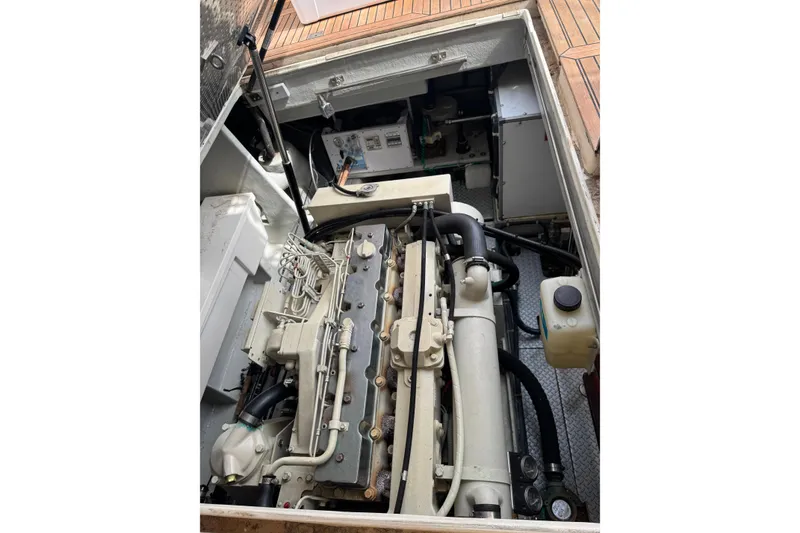 Slide: The Image of Engine compartment of a 2002 Mikelson 50 Sportfisher yacht, showcasing detailed machinery. - 74