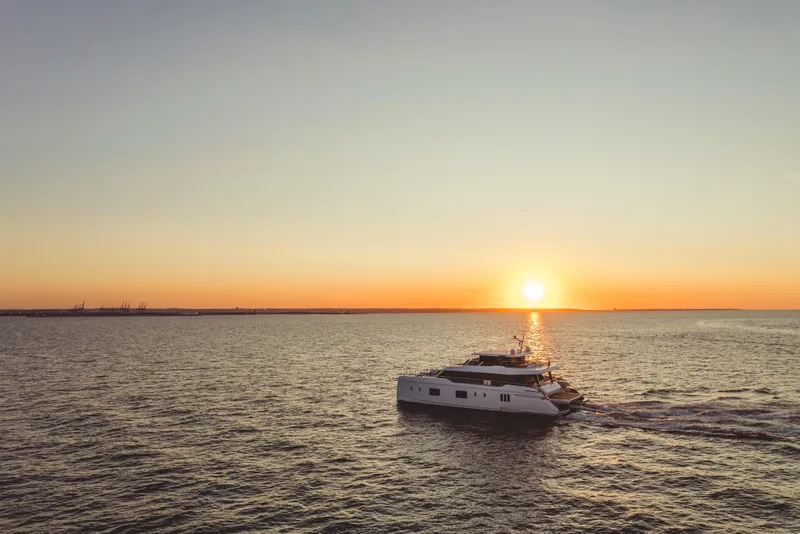 Slide: The Image of 2026 Sunreef 100 Power yacht cruising at sunset on open sea. - 4