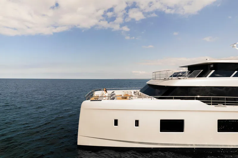 Slide: The Image of Luxury 2026 Sunreef 100 Power yacht cruising on open sea under clear skies. - 5