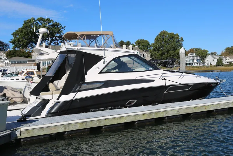 The Image of 2012 Regal 35 Sport Coupe docked at marina, featuring sleek design and modern amenities. - 0