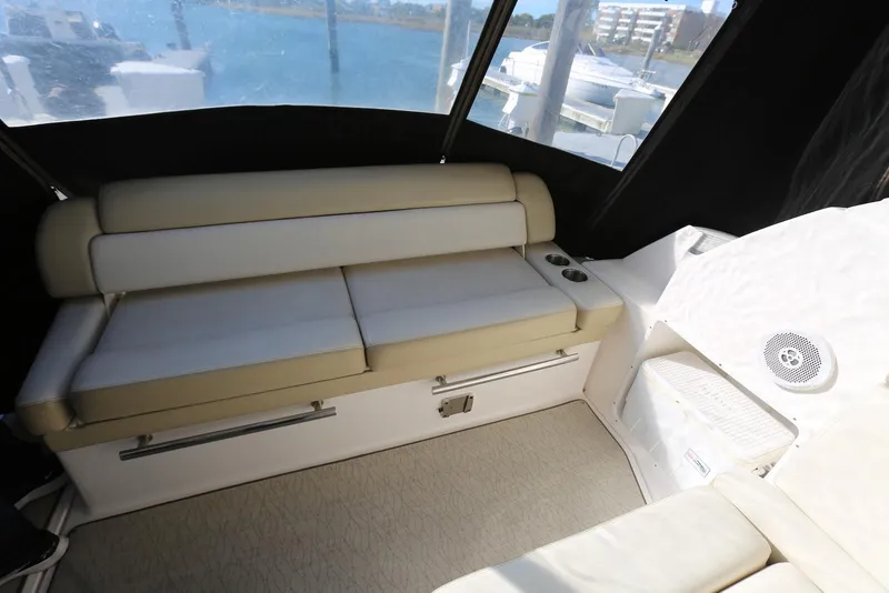 Slide: The Image of Interior seating of 2012 Regal 35 Sport Coupe with beige cushions and cup holders. - 10