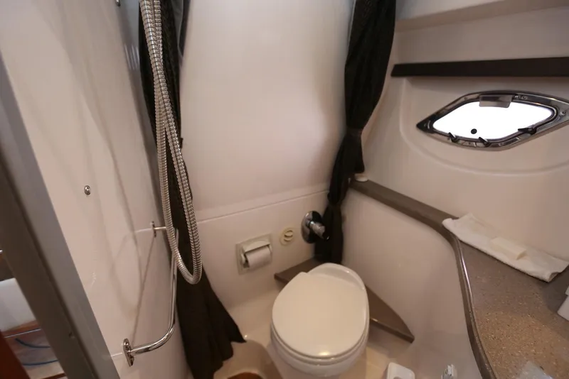 Slide: The Image of 2012 Regal 35 Sport Coupe bathroom with shower, toilet, and porthole window. - 102