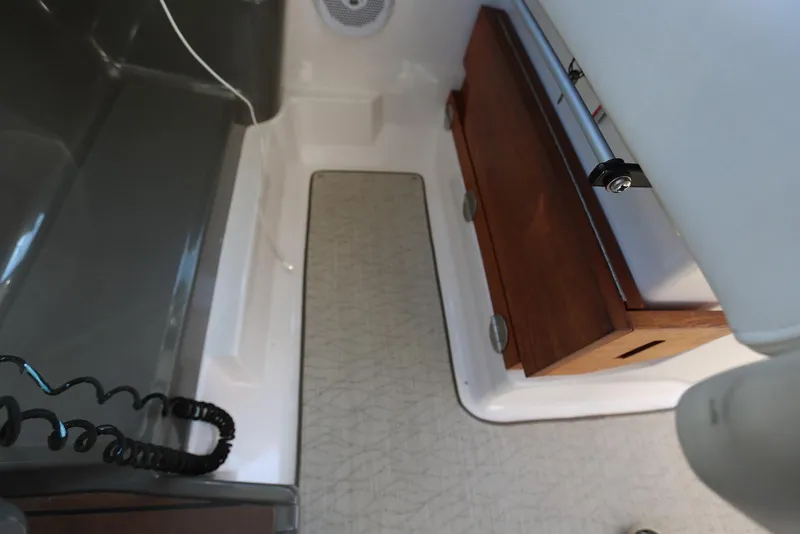 Slide: The Image of Interior view of a 2012 Regal 35 Sport Coupe boat, featuring wooden cabinetry. - 111