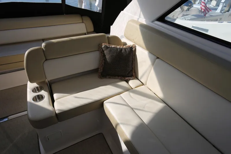 Slide: The Image of Luxurious interior seating of 2012 Regal 35 Sport Coupe with beige upholstery and cup holders. - 14