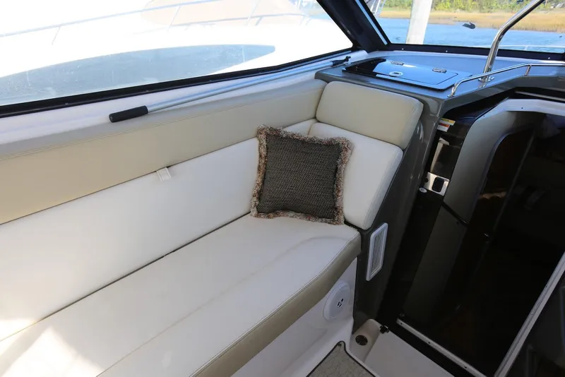 Slide: The Image of Interior of 2012 Regal 35 Sport Coupe with beige seating and decorative pillow. - 15