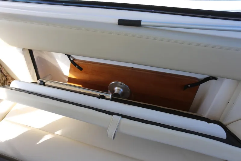 Slide: The Image of 2012 Regal 35 Sport Coupe interior storage compartment with white upholstery and wooden panel. - 16