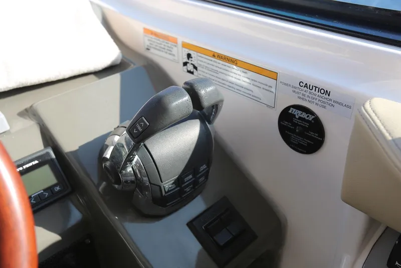 Slide: The Image of Throttle controls on a 2012 Regal 35 Sport Coupe boat dashboard. - 19