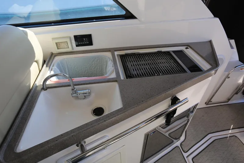 Slide: The Image of 2012 Regal 35 Sport Coupe kitchenette with sink, grill, and countertop. - 20