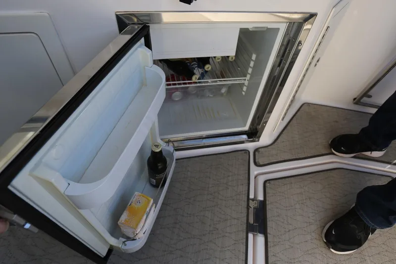 Slide: The Image of Open mini fridge on 2012 Regal 35 Sport Coupe boat, stocked with beverages. - 21