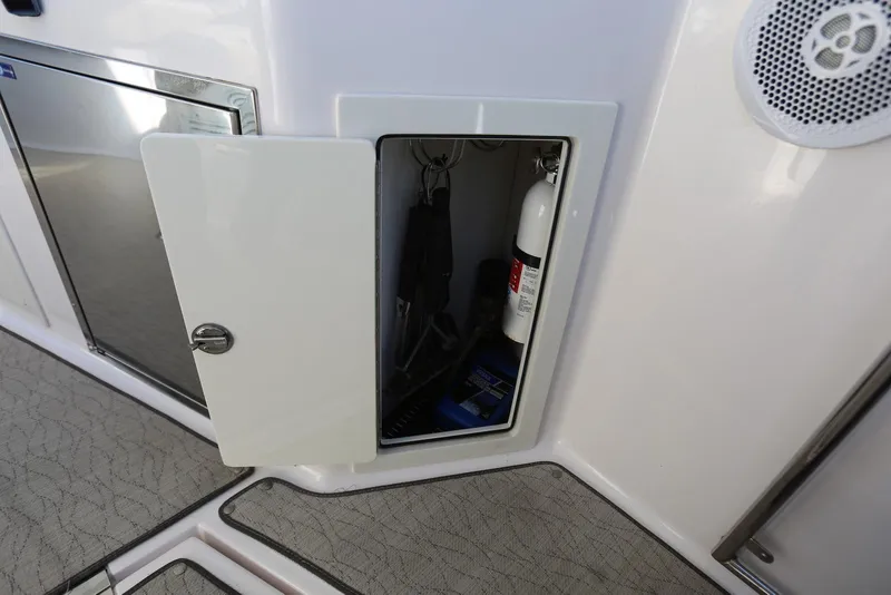 Slide: The Image of Open storage compartment on 2012 Regal 35 Sport Coupe, showing fire extinguisher and equipment. - 22