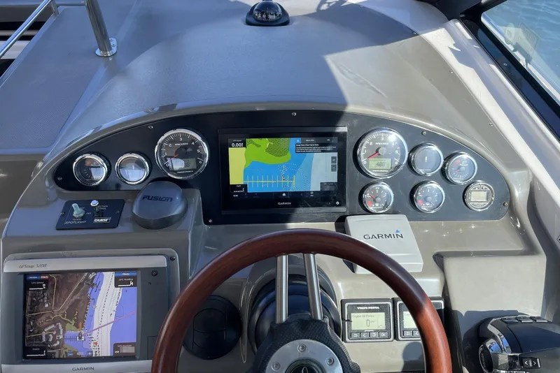 Slide: The Image of ```json
"2012 Regal 35 Sport Coupe dashboard with Garmin navigation and control instruments."
``` - 30