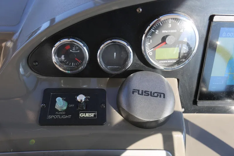 Slide: The Image of Control panel of 2012 Regal 35 Sport Coupe with gauges and spotlight switch. - 38